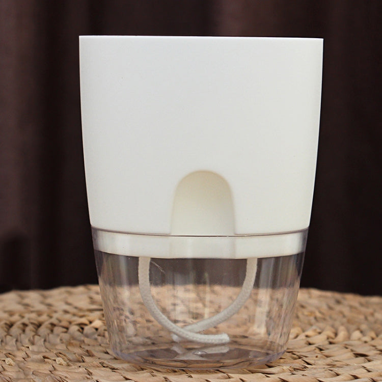 White transparent double-layer plastic flowerpot showing water reservoir through clear sides