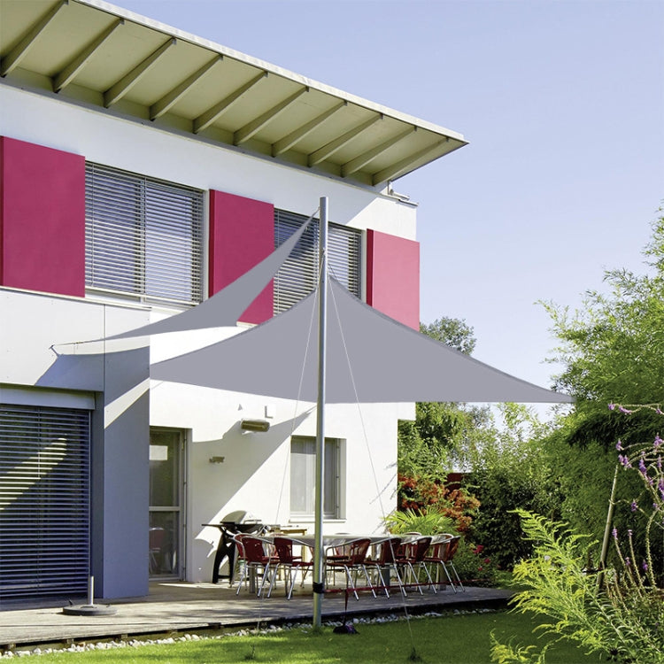 Waterproof sunshade sail canopy stretched over outdoor patio in garden