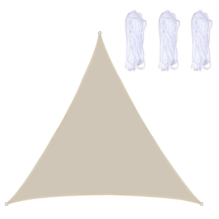 Triangle sunshade sail in beige with corner grommets and hanging ropes.