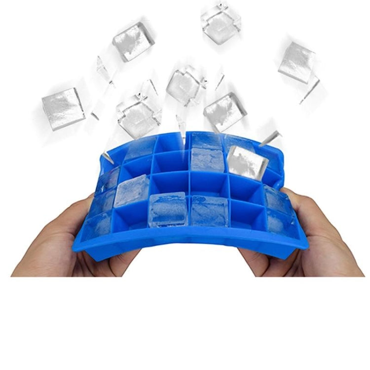 Blue silicone ice cube tray filled with small ice cubes in 24 square compartments