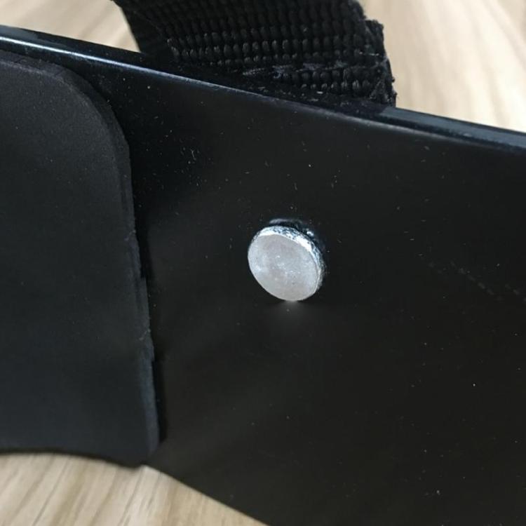 Black metal biceps board with round silver rivet, textured edge padding
