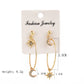 Fashion jewelry card with gold-tone hoop earrings featuring crescent moon and star charms