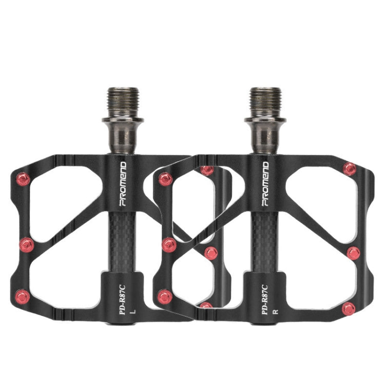 Black carbon fiber platform bike pedals with red screws, dual threaded axles.