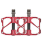Red bicycle platform pedals with carbon fiber bars, dual studs and threaded axles.