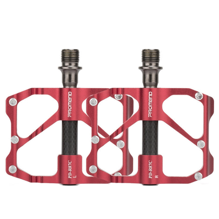 Red bicycle platform pedals with carbon fiber bars, dual studs and threaded axles.