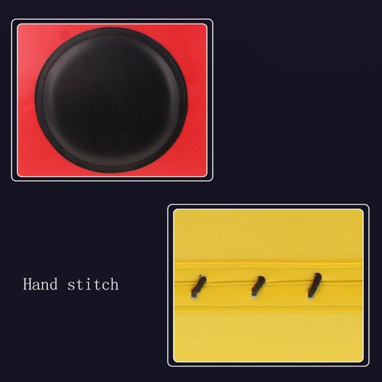 Close-up of red oval striking pad and yellow hand-stitch detail for boxing wall target
