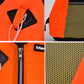 Orange buoyancy vest detail: front zipper, safety pocket, and textured mesh panel.