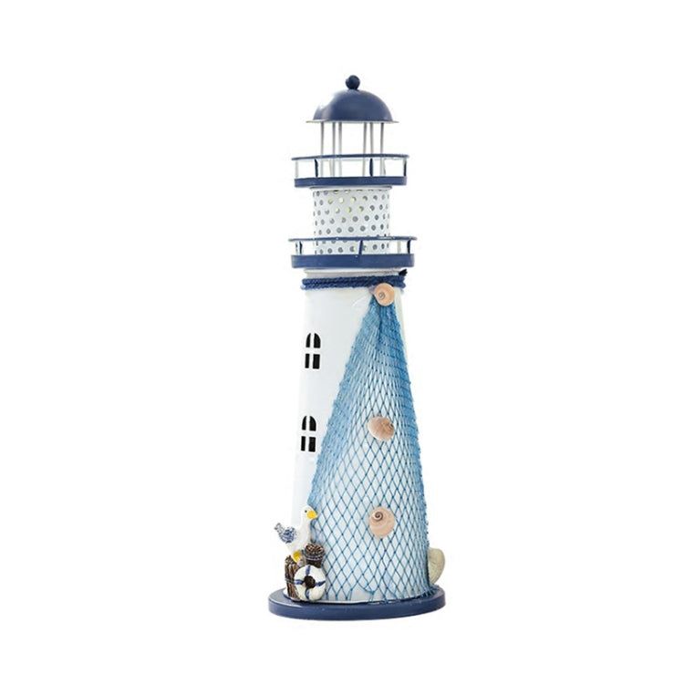 Blue and white tin lighthouse decoration with mesh tower, lantern top, and small boat charm