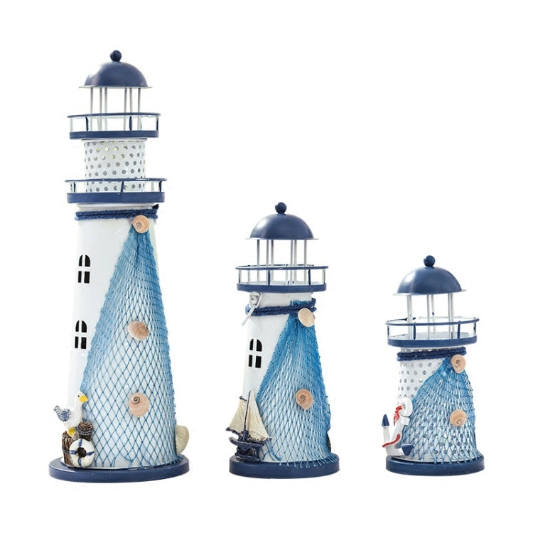 Assorted sizes of blue and white tin lighthouse decorations with mesh bodies and lantern top