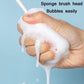 Hand holding white sponge bottle brush head with suds on the cleaning pad