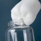 White sponge brush head cleaning inside a clear baby bottle