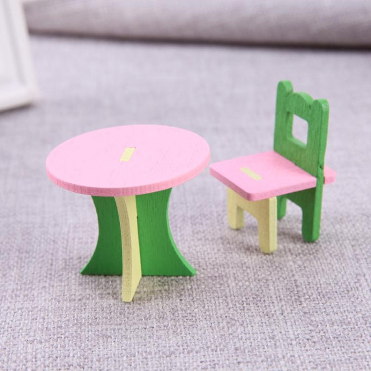 Miniature wooden table and chair set with round pink tabletop and green legs