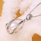 Silver-tone oval cage pendant with natural pearl and rhinestone inlay