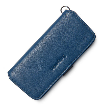 Dark blue leather key case with key ring loop and embossed brand on front