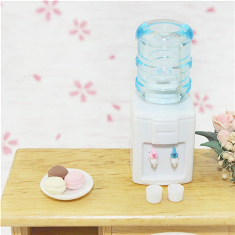 Miniature water dispenser toy with blue clear top, white base, two faucet taps