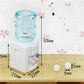 Miniature water dispenser with blue reservoir, white base, two taps and two small cups