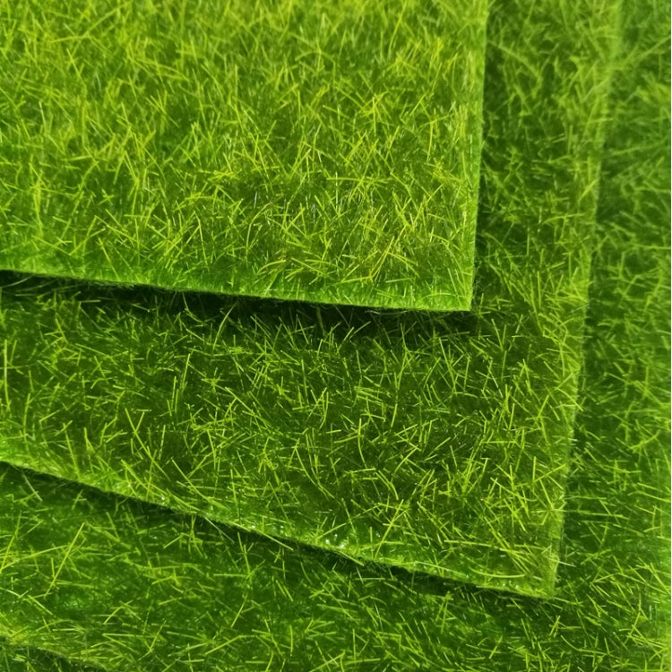 Stacked green artificial turf mats showing layered seams and dense faux moss grass