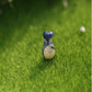Green artificial turf mat with miniature house accessory placed on the faux grass
