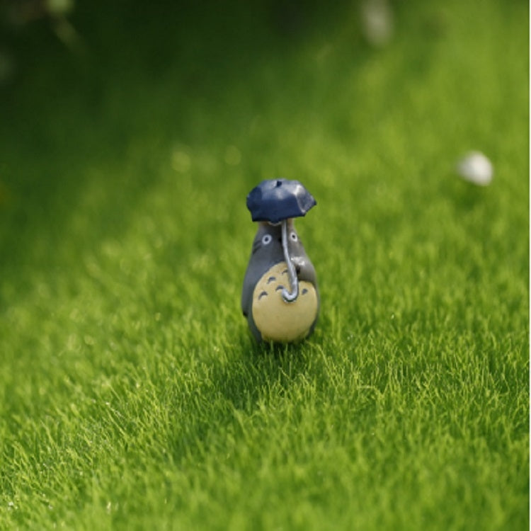 Green artificial turf mat with miniature house accessory placed on the faux grass