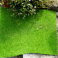 Green artificial turf square mat with straight cut edges and dense faux moss texture