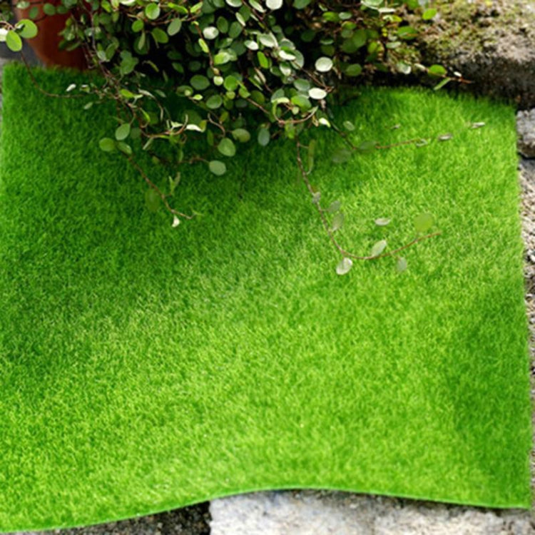 Green artificial turf square mat with straight cut edges and dense faux moss texture