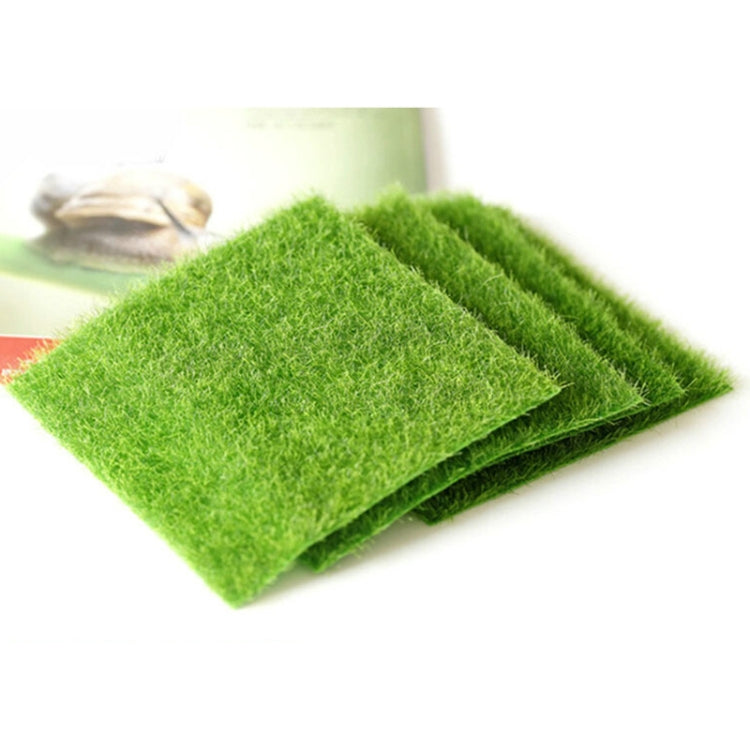 Neatly stacked green artificial turf mats, folded sheets with textured faux moss fibers