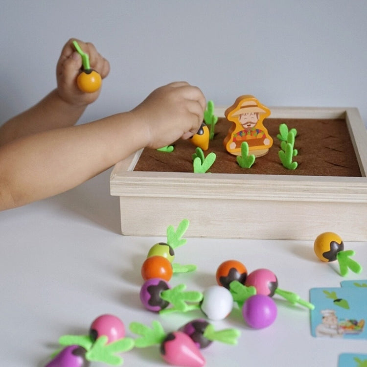 Child hands holding carrot memory pieces over wooden board game