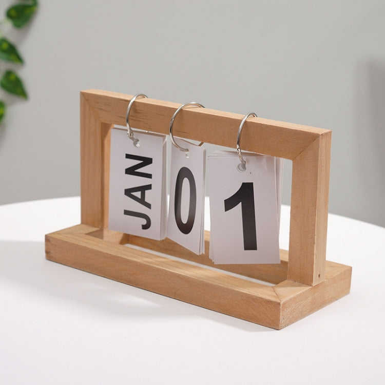 Wooden flipping desk calendar with light wood frame, metal rings, cards showing JAN 01