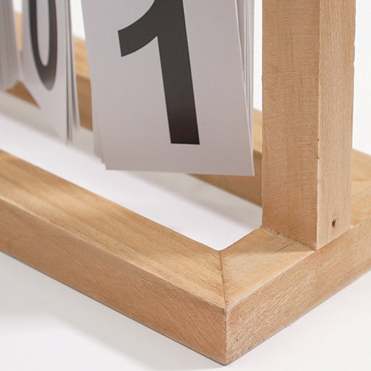 Close-up of wooden flipping desk calendar base and flip cards showing number 01