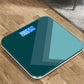 Teal smart electronic scale with blue backlit LCD weight display on tempered glass