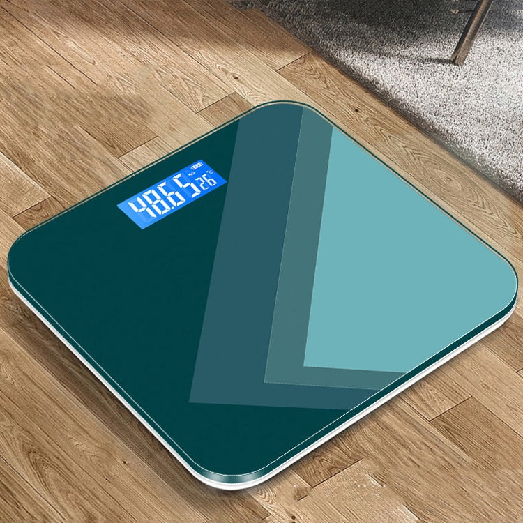 Teal smart electronic scale with blue backlit LCD weight display on tempered glass