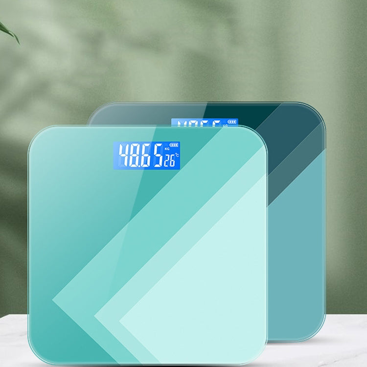 Teal digital body scale with blue LCD reading centered on the glass surface