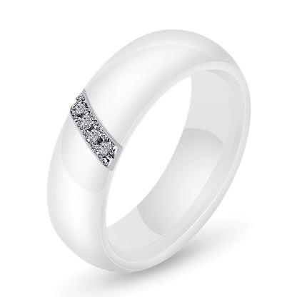 White ceramic ring with zircon crystal inlay across the top