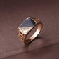 Gold-tone signet ring with black enamel face and rhinestone triangle center