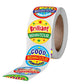 Roll of round award stickers with a strip of stickers coming out