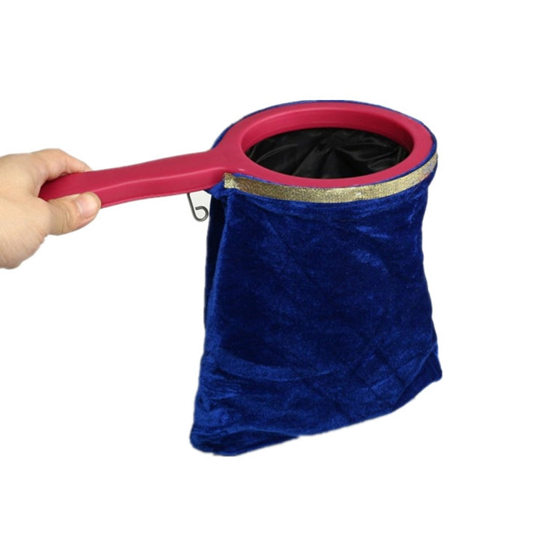 Blue velvet magic change bag prop with pink handle and gold-trimmed opening.