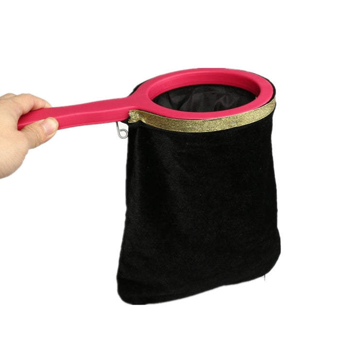Black velvet magic change bag prop with pink handle and gold-trimmed opening.