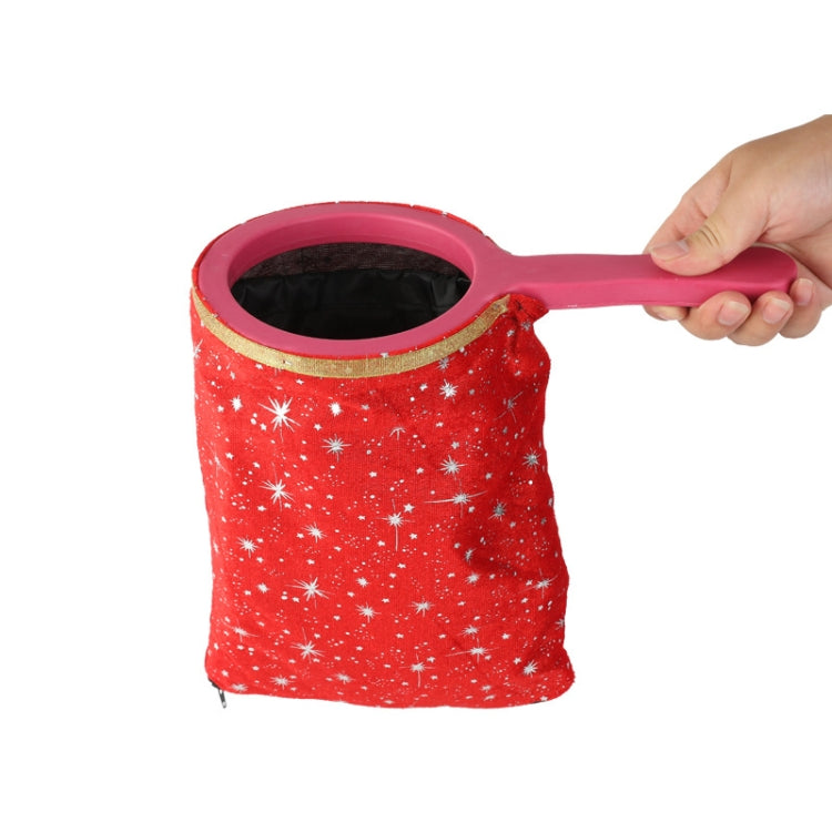 Red star-pattern change bag prop with pink handle and gold-trimmed opening.