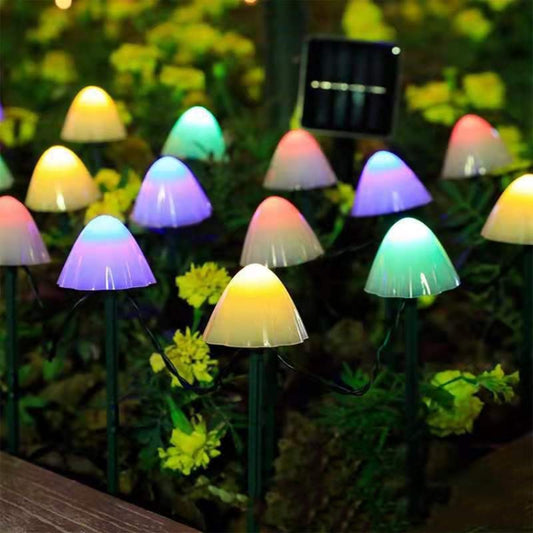 Outdoor solar mushroom string lights with multicolor glowing caps on garden stakes