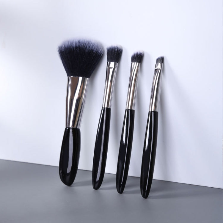 Four black-handled makeup brushes with silver ferrules and soft bristles