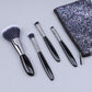 Makeup brush set with black-handled soft bristle brushes and glitter zip pouch