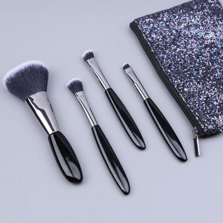 Makeup brush set with black-handled soft bristle brushes and glitter zip pouch