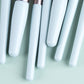 Close-up of sky blue mini brush handles with soft bristles