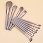 12-piece makeup brush set with lilac handles and brown bristles, angled view