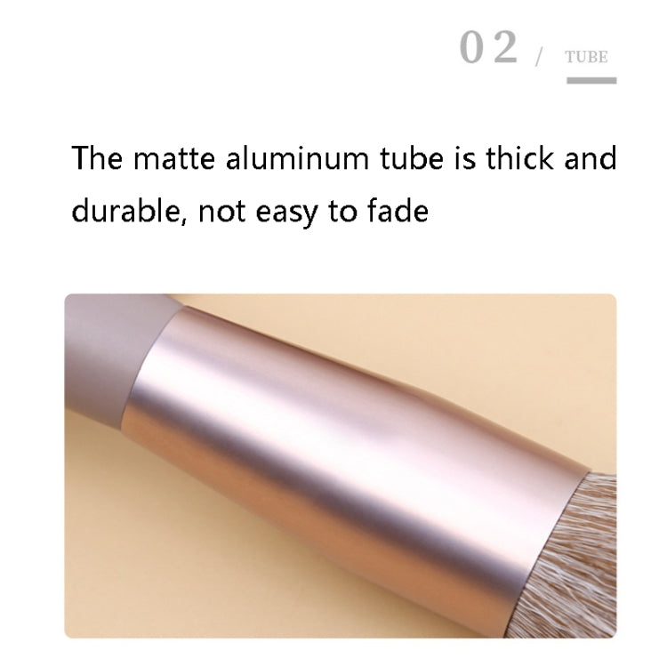 Close-up of silver ferrule on a lilac makeup brush with brown bristles