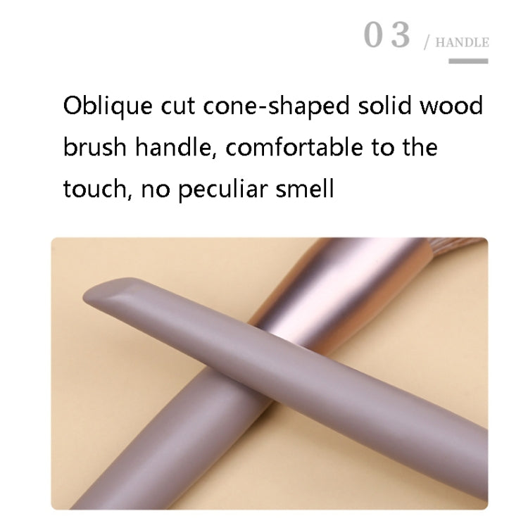 Close-up of oblique wooden handle on lilac makeup brush with brown bristles