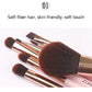 Pink-handled makeup brushes with dense brown bristles and gold ferrules