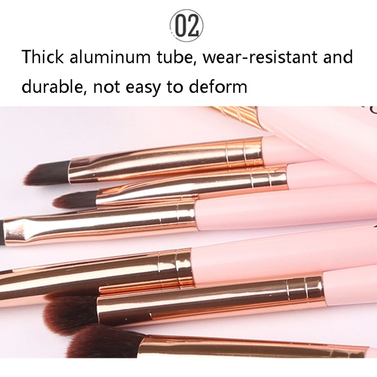 Pink-handled makeup brushes with gold metal tubes and brown bristles