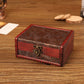 Vintage wooden jewelry box with red sides, dark engraved pattern, and bronze clasp