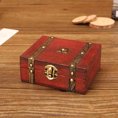 Red wooden jewelry box with brass corner studs and central clasp lock